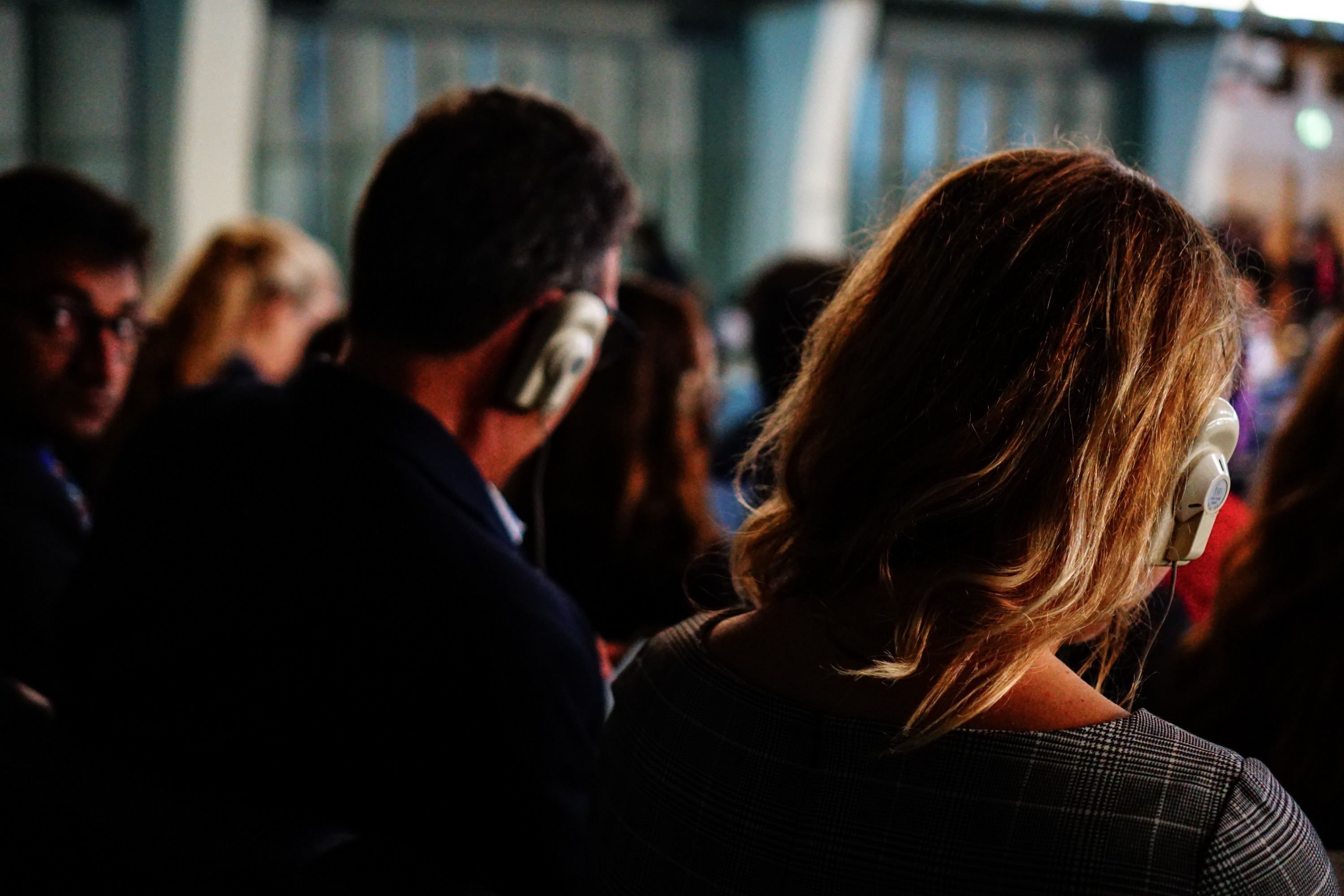 Frank Sesno and Lindsay Eberhart listen on the translator during the plenary session on day 1.